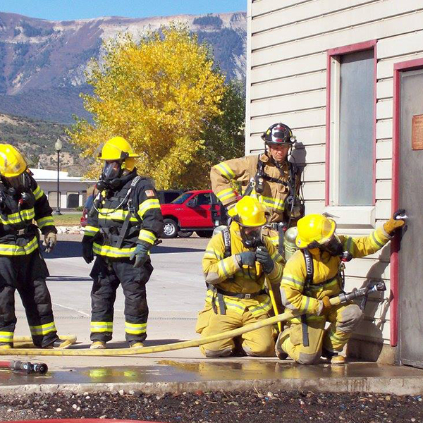 Firefighters training, using tools to open a door
